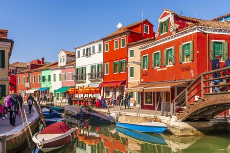 Canal and its typical facades on the island of Burano in Venice in Veneto, Italyの写真素材