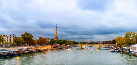 The Eiffel Tower seen from the Alexandre III bridge over the Seine at dusk in Paris in Ile de France, Franceのeditorial素材