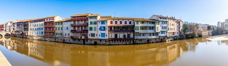 Facades of houses in the town of Castres on the Agout River in Occitanie, France