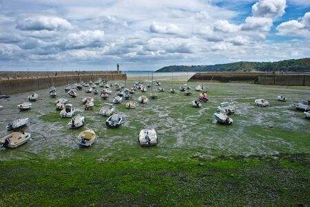 boats stranded on the port of Binic, at base tide, in Brittany in the coasts of Armorの写真素材