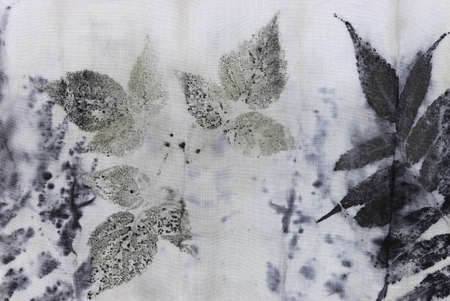 detail of black imprint of natural leaves on a cotton fabricの写真素材