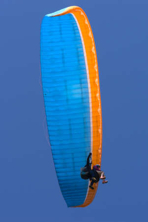 Tandem blue and orange paragliding flight, first flightの写真素材
