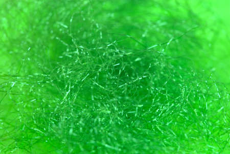 tangled shiny green synthetic fiber background in macro shotの写真素材
