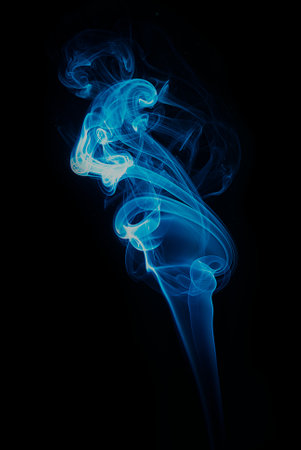 swirl of blue smoke isolated on black backgroundの写真素材