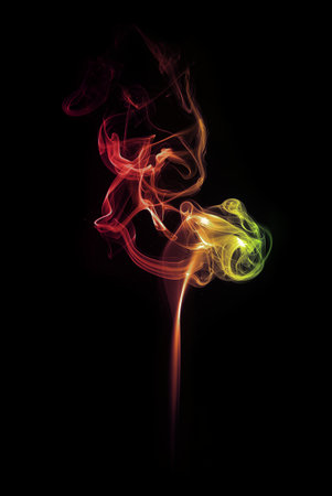 swirl of red and yellow smoke isolated on blackの写真素材