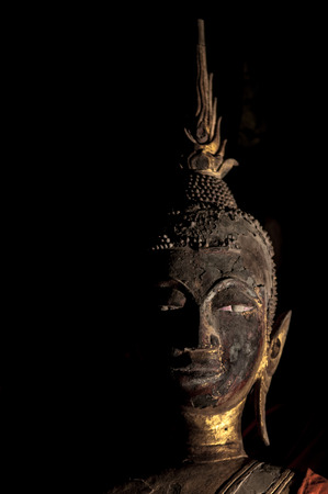 Head shot of old Buddha Sculptures at Wat Xieng thongの写真素材