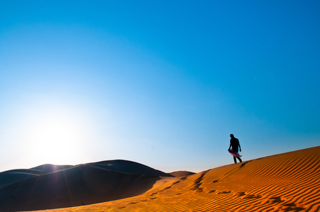 One man is standing alone in Al Wathba desert. Abu Dhabi.の写真素材
