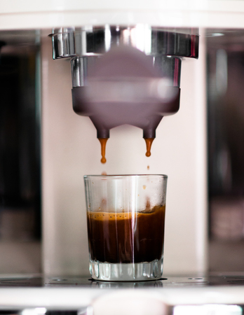 Making an espresso shot with home coffee machine.の写真素材