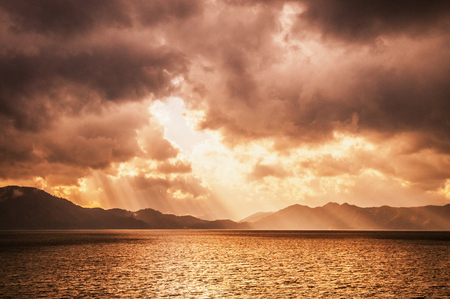 Sunset sky before storm with divine ligth at lake Tazawa, Semboku, Akita, Japan.の写真素材