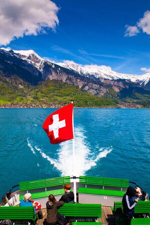 May 4, 2016 - Brienz, Switzerland : Ferry ship in Lake Brienz with swiss flag and view of  Mt. Brienzer Rothornのeditorial素材
