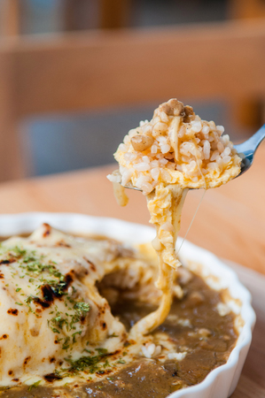 Japanese Kare Omu rice, Japanese omelette rice with curry on spoonの写真素材