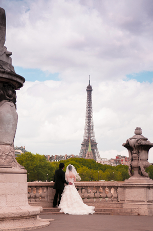 JUNE 9, 2011 Paris, France : wedding couple and Eiffel tower on cloudy dayのeditorial素材