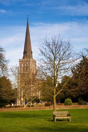 Park, bench and small church in outer Londonの写真素材