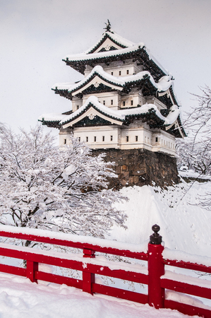 White Hirosaki Castle and its red wooden bridge in mid winter season, Aomori, Tohoku, Japanのeditorial素材