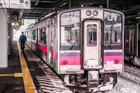 JAN 21, 2014 Hirosaki, Aomori, Japan : Pink strip JR East 701 Series commutor train at Hirosaki...