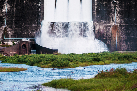 Khun Dan Prakan Chon Dam with a lot of water ran through open spillway in Nakhon Nayok, Thailandのeditorial素材