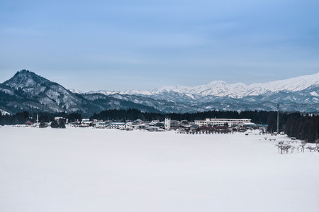 Wide landscape of small village and mountain range in Fukushima, Tohoku, Japan in Winterの写真素材