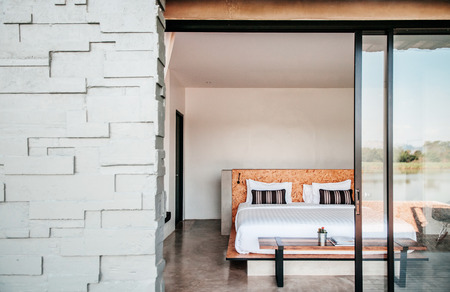FEB 23, 2015 Kanchanaburi, Thailand : White contemporary hotel style bedroom with gray color stone wall exterior decorationのeditorial素材