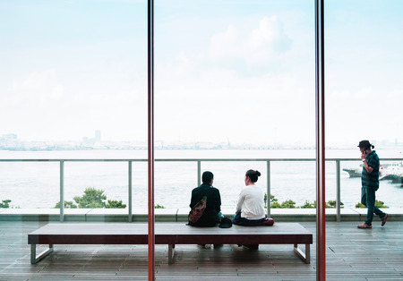 Jun 26, 2014 Yokohama, Japan : Observatory deck of Cup noodles museum in Yokohama with an  asian couple sit on wood bench looking over Yokohama bay.の写真素材