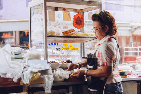 MAR 1, 2018 Uthaithani, Thailand : Thai local street food noodle shop with female home cooking chefのeditorial素材