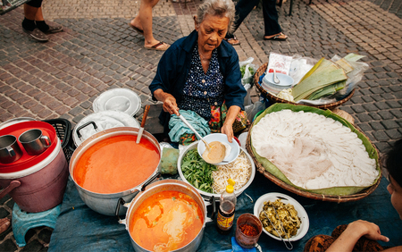 MAR 2, 2018 Uthaithani, THAILAND : Local Thailand market sellers at a traditional Street food shop...