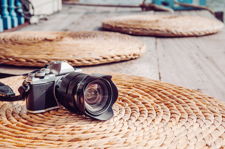 Front view old vintage retro style camera on dried water hyacinth mat natural texture background with copy space. Photographer lifestyle image conceptの写真素材
