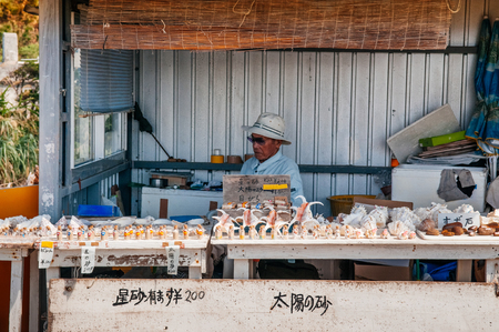 JAN 31, 2013 Okinawa, Japan : Old Okinawan man in local star sand souvenir shop at Hoshizuna beach, Iriomote island,のeditorial素材