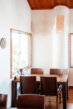 JAN 30, 2018 Miyako, Okinawa - Japan : Warm cozy Japanese style restaurant decoration with wooden furniture white wall and natural lightのeditorial素材