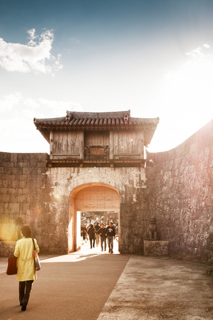 Old wall and fortress of Shuri (Shurijo) Castle under clear blue sky with tourists, Naha, Okinawa, Japanのeditorial素材