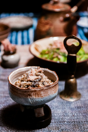 Traditional Okinawa cuisine food set fried tofu skin and mushroom in craft ceremic bowlの写真素材
