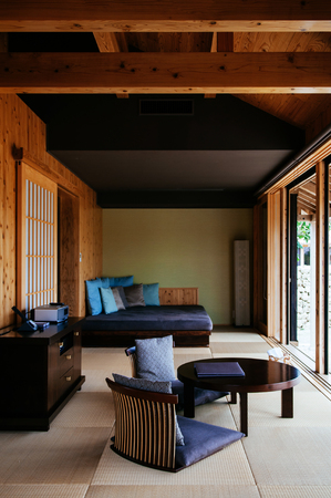FEB 1, 2013 Takeyomi, Okinawa, JAPAN : Modern contemporary Japanese style living rooom, with sliding door, seat, table, daybed and craft fabric pillow.のeditorial素材