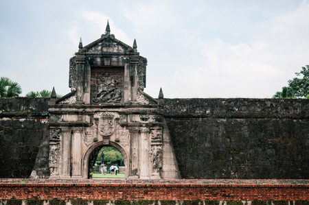 NOV 20, 2012 Manila, Philippines : Old historic entrance gate and moat of Fort Santiago with tourist in Intramuros district