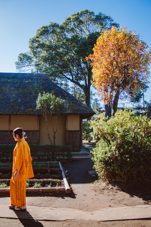 DEC 11, 2012 Chiba, JAPAN - Old vintage wooden thatched roof Japanese Samurai house and woman in Yukata dress. Sakura city, famous Edo Samurai village near Tokyo.のeditorial素材
