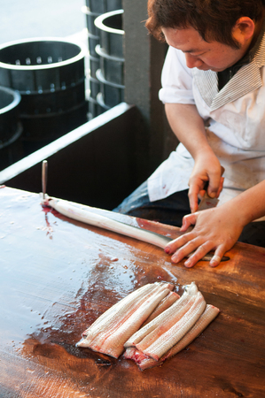 DEC 12, 2012 Narita, Chiba, JAPAN - Male Chef Preparing raw Unagi eel for Unagi donburi or charcoal grilled Unagi in Narita, Japanのeditorial素材
