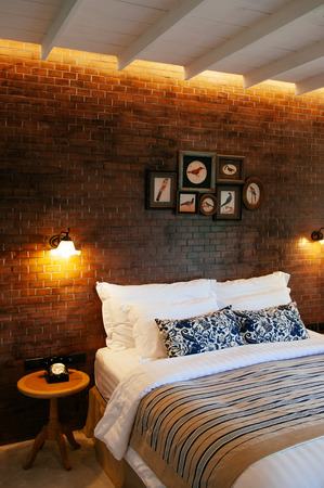 JUN 13, 2013 Thailand : English country vintage bedroom interior with natural light through window, pillow, wooden furniture, wall ornaments decorationのeditorial素材