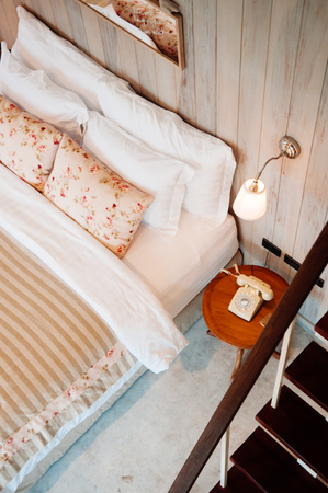 JUN 13, 2013 Thailand : English country vintage bedroom interior with natural light through window, pillow, wooden furniture, wall ornaments decorationのeditorial素材