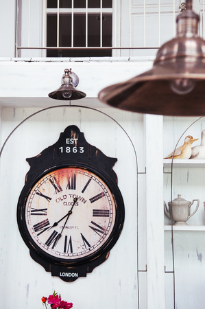 Old Retro vintage clock on white wall in country houseの写真素材