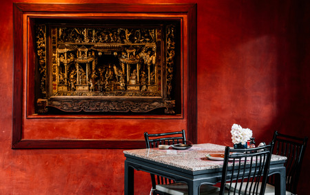 JUN 5, 2013 Chiang Mai, THAILAND - Nice vintage Chinese interior style dinning room with lamp, table, wooden chair red wall. warm lightのeditorial素材