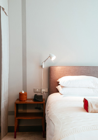 JUN 6, 2013 Chiang Mai, THAILAND - White contemporary bedroom with white linen and wood furnitureのeditorial素材