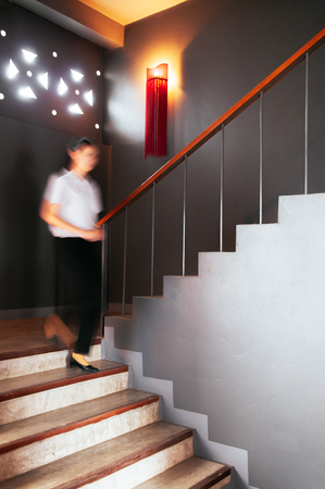 JUN 6, 2013 Chiang Mai, THAILAND - Woman walking down from contemporary style concrete stairwellのeditorial素材