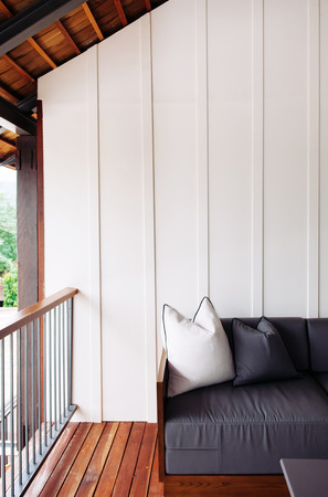 JUN 6, 2013 Chiang Mai, THAILAND - Cozy couch at contemporary style balcony with evening sunlightのeditorial素材