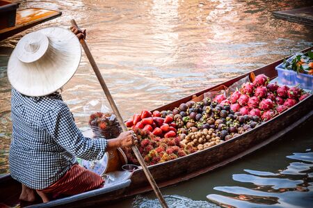 Fruits selling boat Floating market in Thailand. Damnoen Saduak floating market in Ratchaburiの写真素材