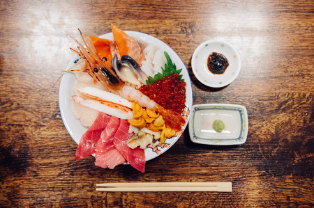 Kaisendon premium Japanese sashimi rice bowl on wood table top view shot