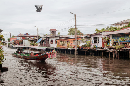 JUL 10, 2018 Bangkok, Thailand - Thai long tail boat with garlands in Banhkok's canal (Klong), famous river and canal transportationのeditorial素材