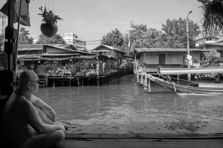 APR 20, 2013 Bangkok, Thailand - Thai wooden houses along Bangkok Yai canal or Klong Bang Luang with long tail boat ran passedのeditorial素材