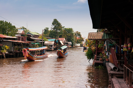 APR 20, 2013 Bangkok, Thailand - Thai wooden houses along Bangkok Yai canal or Klong Bang Luang with long tail boat ran passedのeditorial素材