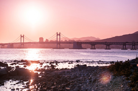 Gwangan bridge against sunset view from Dongbaek island in the Haeundae District, Busan, South Koreaの写真素材