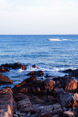 Boat and Rock beach Dongbaek island sunset in the Haeundae District, Busan, South Koreaの写真素材