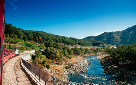 OCT 24, 2013 Gangwon-do, South Korea - V-Train sightseeing train run along stream and valley of famous tourist train route for autumn & winter between Buncheon - Cheoram stations.のeditorial素材