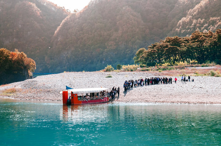 OCT 23,2013 Gangwon-do, South Korea - Many tourists boarding on boat at Cheongryeongpo cape. Famous tourist attraction of Yeongwol town.のeditorial素材
